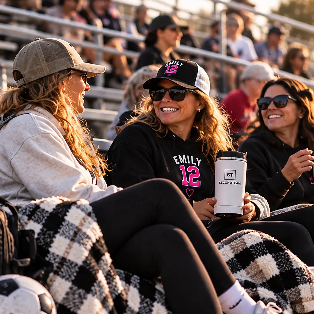 Parents laughing together on the bleachers at golden hour