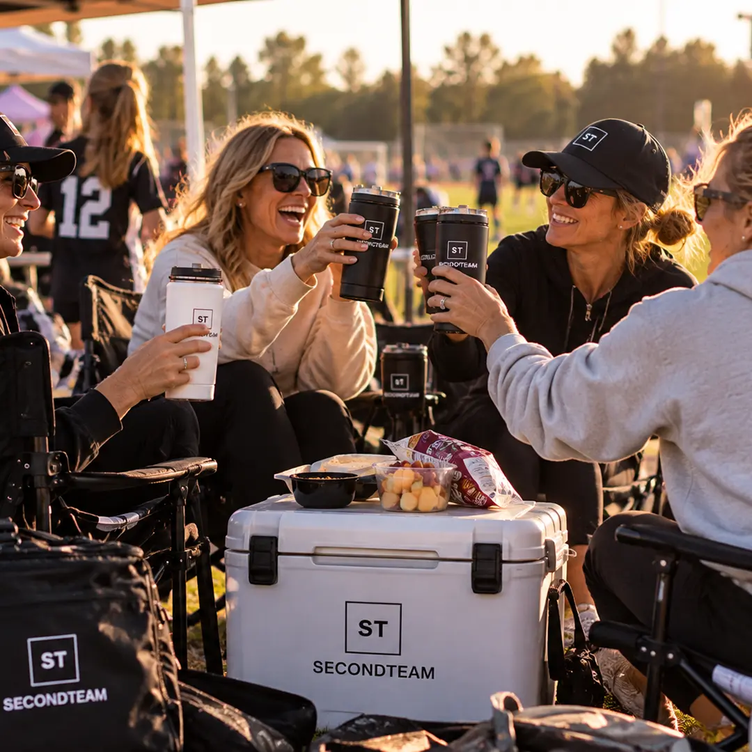Parents toasting with SECONDTEAM tumblers on the sideline